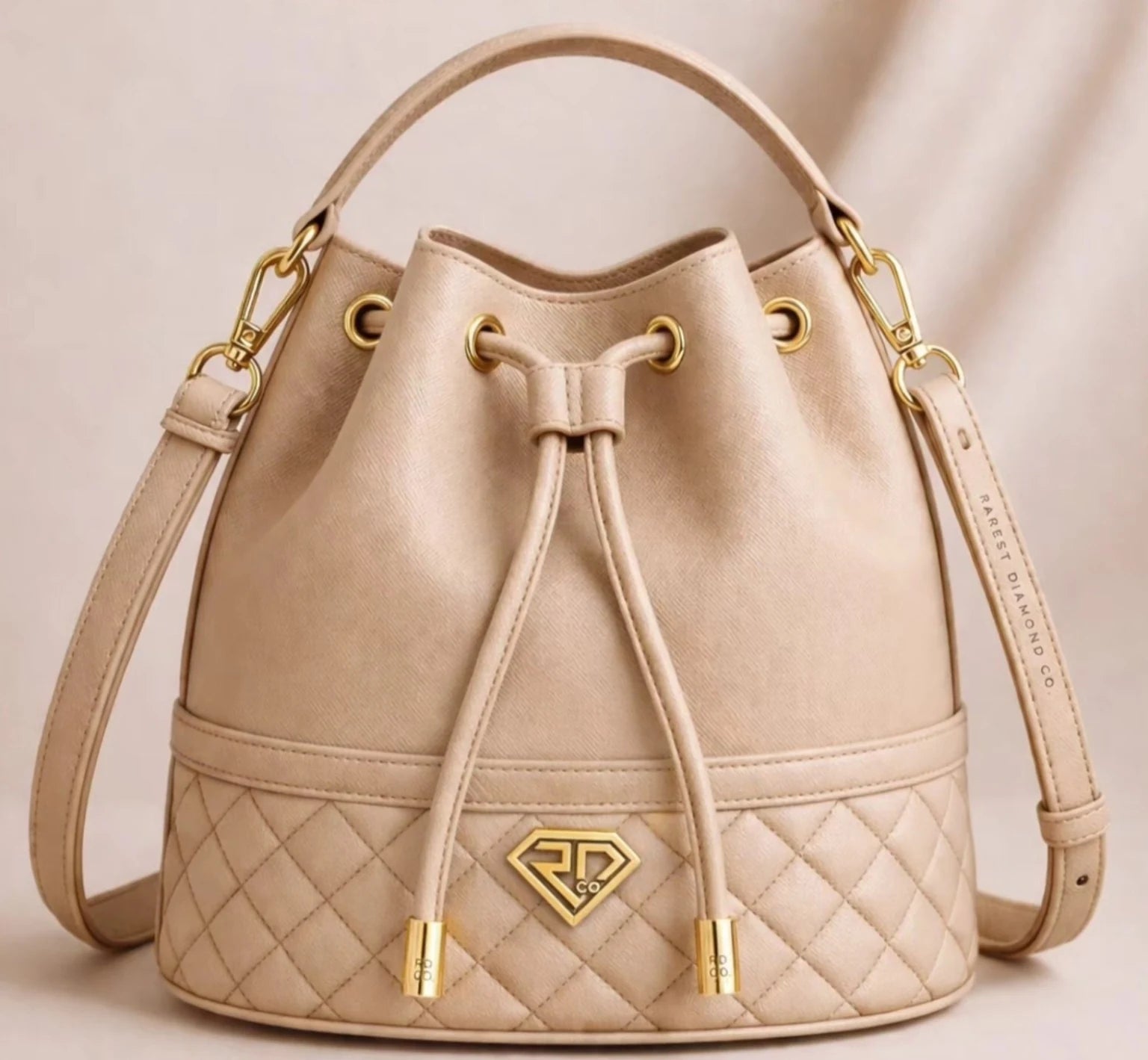 Cream Rarest Diamond® Co. bucket bag with gold hardware