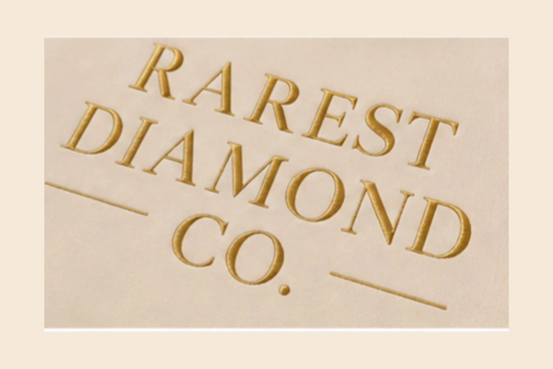 Close view of the gold Rarest Diamond Co. chest design on cream fabric